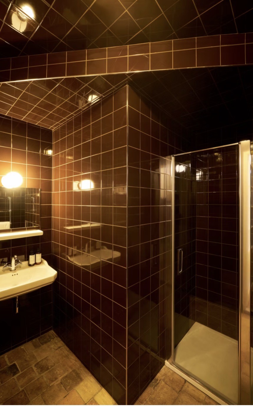 A dark tiled shower