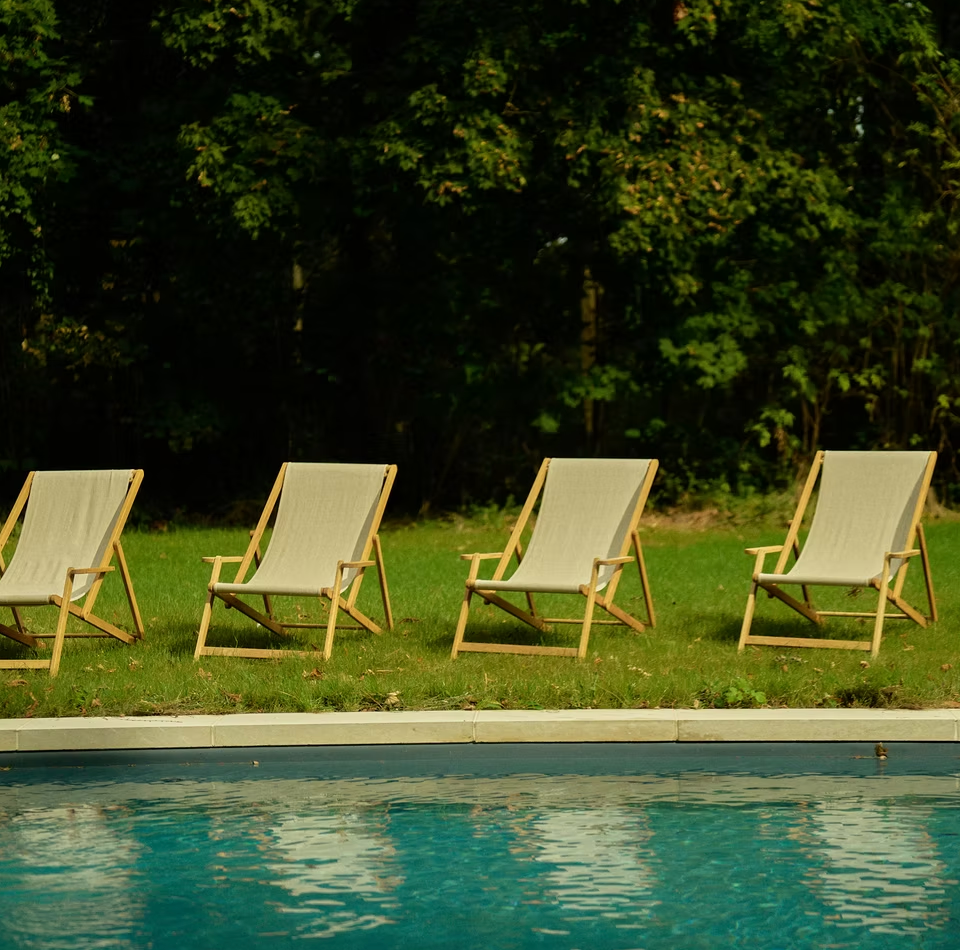 Poolside chairs on the château grounds