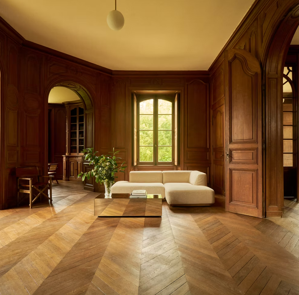 A sunlit wood-paneled salon